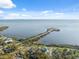 Beautiful aerial view of waterfront homes with scenic bay views and bright sunny skies at 108 Shore Dr, Tarpon Springs, FL 34689