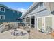 Back porch with outdoor seating, a grill, and an adjacent structure with white trim at 108 Shore Dr, Tarpon Springs, FL 34689