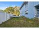 View of the house exterior and overgrown backyard showing the need for landscaping and property maintenance at 108 Shore Dr, Tarpon Springs, FL 34689