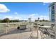 Waterfront balcony with patio furniture, tile flooring, and view of the surrounding foliage at 108 Shore Dr, Tarpon Springs, FL 34689
