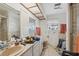 Bathroom featuring a double vanity, tiled walls, and a shower with glass doors at 108 Shore Dr, Tarpon Springs, FL 34689