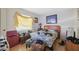 Bedroom with Packers themed bedding, wood flooring, and natural light from the window at 108 Shore Dr, Tarpon Springs, FL 34689