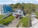 Exterior aerial view featuring homes with lush landscaping, inviting front porches, and ample parking space at 108 Shore Dr, Tarpon Springs, FL 34689