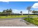 Street view featuring a well-maintained landscape with palm trees, lush green lawns, and a charming mailbox at 108 Shore Dr, Tarpon Springs, FL 34689