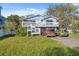 Charming two-story home with a spacious front deck and well-maintained yard with parking for multiple cars at 108 Shore Dr, Tarpon Springs, FL 34689