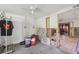 Spacious garage with unfinished construction, peeling paint, and a ceiling fan at 108 Shore Dr, Tarpon Springs, FL 34689