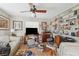 Comfortable living room featuring a ceiling fan, built-in bookshelves, and large window at 108 Shore Dr, Tarpon Springs, FL 34689