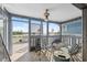 Screened porch with seating, view of water and trees, tile flooring at 108 Shore Dr, Tarpon Springs, FL 34689