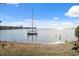 Beautiful water view of a boat dock and calm water, framed by green foliage at 108 Shore Dr, Tarpon Springs, FL 34689