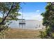 Beautiful water view of a boat dock and calm water, framed by green foliage at 108 Shore Dr, Tarpon Springs, FL 34689