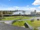 Scenic water view featuring lush green landscaping, palm trees, and a distant shoreline under a blue sky at 108 Shore Dr, Tarpon Springs, FL 34689