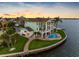 Waterfront home with a pool and manicured lawn on a coastal property at 11000 8Th E St, Treasure Island, FL 33706