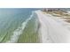 Breathtaking aerial view of a pristine beach with crystal-clear turquoise water and soft white sand at 11000 8Th E St, Treasure Island, FL 33706
