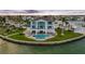 Stunning waterfront home with a private pool and lush landscaping, offering luxurious outdoor living at 11000 8Th E St, Treasure Island, FL 33706