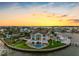Stunning aerial view of a coastal home featuring a waterfront pool and lush landscaping at 11000 8Th E St, Treasure Island, FL 33706