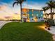 Backyard features well-maintained lawn, patio, and bay access, perfect for outdoor enjoyment at 11000 8Th E St, Treasure Island, FL 33706