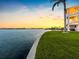 Backyard features well-maintained lawn and bay access, perfect for outdoor enjoyment at 11000 8Th E St, Treasure Island, FL 33706
