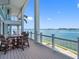 Wide balcony with comfortable seating offers an open outdoor space and expansive water views at 11000 8Th E St, Treasure Island, FL 33706