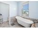 Bathroom with a clawfoot tub, marble flooring, and a serene atmosphere at 11000 8Th E St, Treasure Island, FL 33706