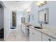 Elegant bathroom with dual vanities, granite countertops, and decorative fish-themed decor at 11000 8Th E St, Treasure Island, FL 33706