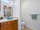 Stylish bathroom with vessel sink, granite countertops, wood cabinets, and modern fixtures at 11000 8Th E St, Treasure Island, FL 33706
