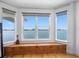 Window nook with wooden base and storage overlooking the water with views of the city in the distance at 11000 8Th E St, Treasure Island, FL 33706