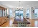 Dining area with seating for six showcasing water views, stylish decor, and natural light at 11000 8Th E St, Treasure Island, FL 33706