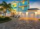 Charming coastal home with three-car garage, manicured landscaping, and a paver driveway at 11000 8Th E St, Treasure Island, FL 33706
