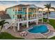 Waterfront home with balconies, outdoor seating, and a sparkling pool at 11000 8Th E St, Treasure Island, FL 33706