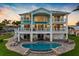 Waterfront estate with multiple balconies, a pool, and outdoor entertaining space at 11000 8Th E St, Treasure Island, FL 33706