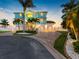 Well-maintained coastal home with a three-car garage, a paver driveway, and lush landscaping at 11000 8Th E St, Treasure Island, FL 33706