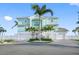 Charming coastal home with a three-car garage, lush landscaping, and inviting curb appeal at 11000 8Th E St, Treasure Island, FL 33706