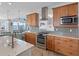 Gourmet kitchen with stainless steel appliances, granite countertops and custom backsplash at 11000 8Th E St, Treasure Island, FL 33706