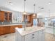 Bright kitchen features wood cabinets, stainless steel appliances, and a center island with white countertops at 11000 8Th E St, Treasure Island, FL 33706
