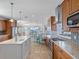 Spacious kitchen with stainless steel appliances, granite countertops, and water views at 11000 8Th E St, Treasure Island, FL 33706