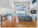 Spacious living room featuring high ceilings, water views, hardwood floors and stylish nautical decor at 11000 8Th E St, Treasure Island, FL 33706