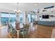 Open-concept living space with water views, dining area, hardwood floors, and stylish furniture at 11000 8Th E St, Treasure Island, FL 33706