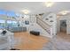 Expansive living area showcasing staircase, nautical decor, hardwood floors and plenty of natural light at 11000 8Th E St, Treasure Island, FL 33706