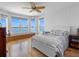 Main bedroom features a bay window overlooking the water, white furniture, and hardwood floors at 11000 8Th E St, Treasure Island, FL 33706
