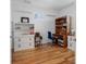 Home office features hardwood floors, shutters on the window, and ample desk and cabinet space at 11000 8Th E St, Treasure Island, FL 33706