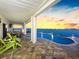 Entertaining patio with a bay view, overlooking the outdoor pool area at 11000 8Th E St, Treasure Island, FL 33706