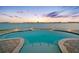 Infinity pool overlooking the water during sunset with an amazing view of the cityscape at 11000 8Th E St, Treasure Island, FL 33706