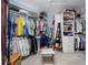Large walk-in closet with custom shelving, organized storage, and a comfortable seating area at 11000 8Th E St, Treasure Island, FL 33706