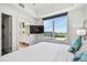 Bright bedroom featuring a large window with city views and a wall-mounted television at 11500 Gulf Blvd # 513, Treasure Island, FL 33706