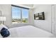 Well lit bedroom with wall mounted tv and city views at 11500 Gulf Blvd # 513, Treasure Island, FL 33706