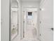 Bright hallway leading to a bathroom with marble floors and white walls at 11500 Gulf Blvd # 513, Treasure Island, FL 33706