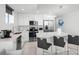 Modern kitchen featuring stainless steel appliances, a breakfast bar, and sleek white cabinetry at 11500 Gulf Blvd # 513, Treasure Island, FL 33706