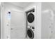 Laundry area with stacked washer and dryer units, and additional storage space at 11500 Gulf Blvd # 513, Treasure Island, FL 33706