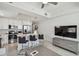 Bright living room with modern kitchen island, stainless steel appliances, and a large TV at 11500 Gulf Blvd # 513, Treasure Island, FL 33706