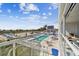 Scenic pool view from the building, showcasing outdoor relaxation, beach access, and a vibrant vacation atmosphere at 11500 Gulf Blvd # 513, Treasure Island, FL 33706